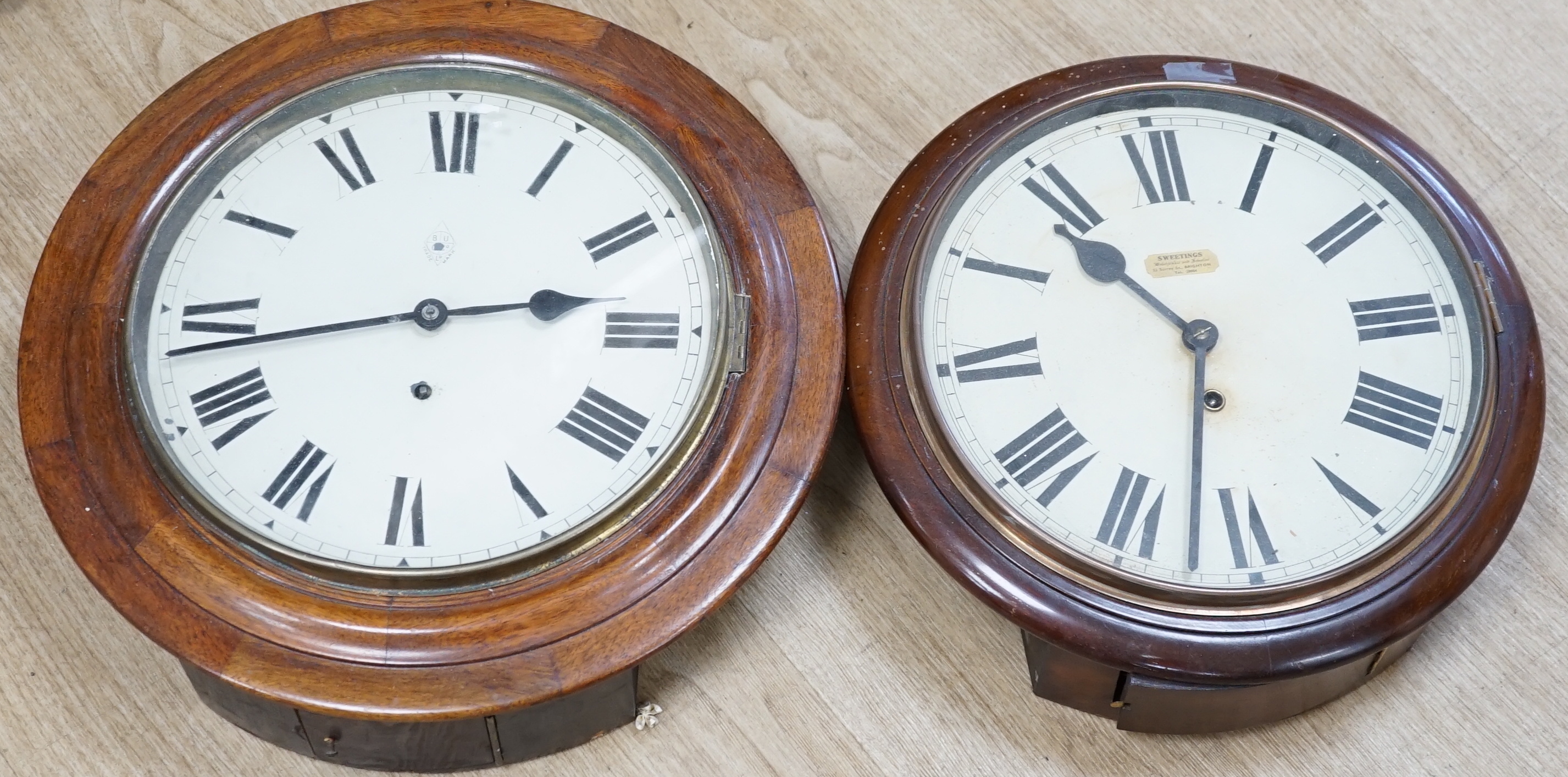 Two early 20th century circular mahogany dial clocks, largest diameter 43cm